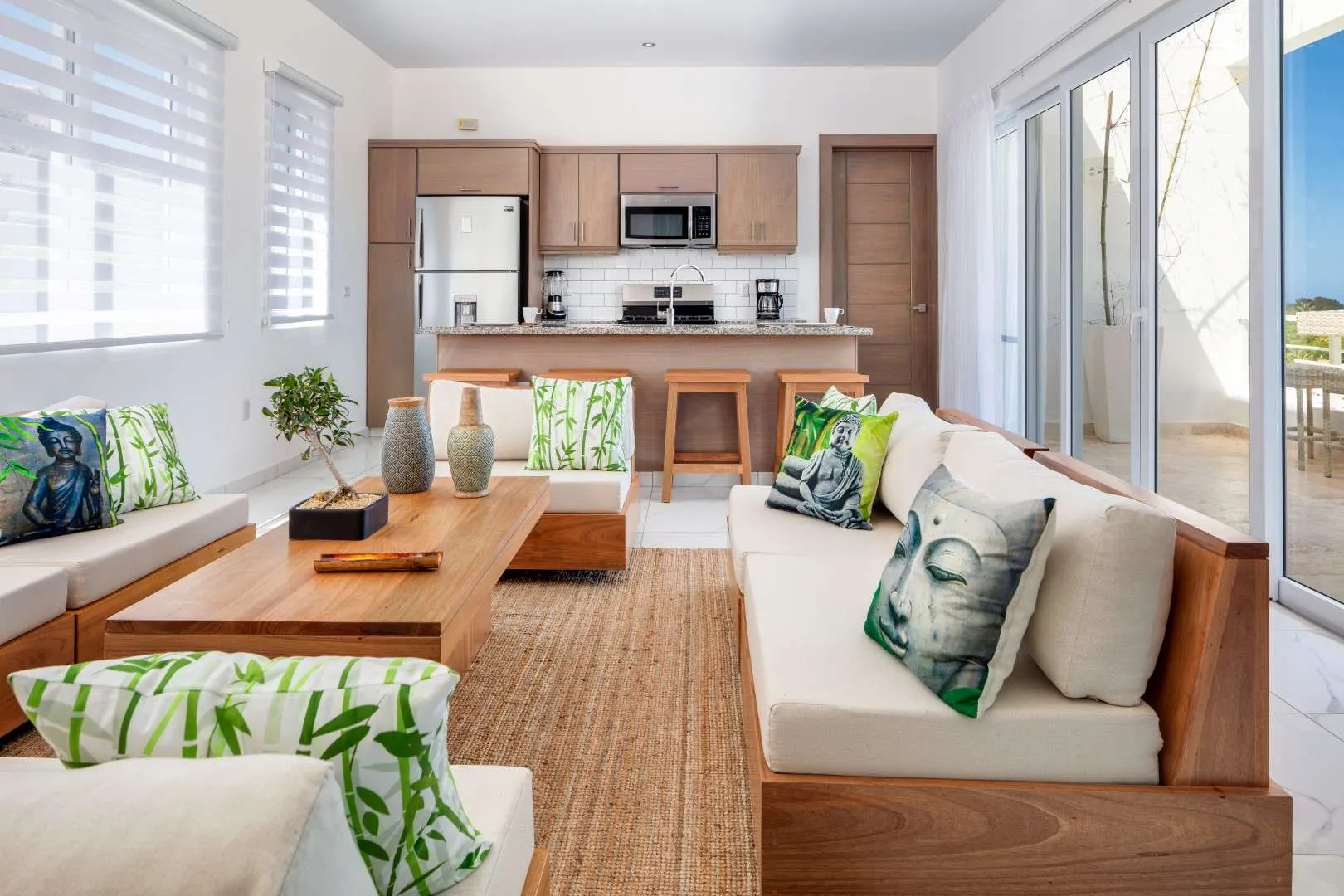 buyDRproperty Villa Seashell Casa Linda: Living room with Buddha pillows, bamboo accents, and kitchen. Sosua Real Estate