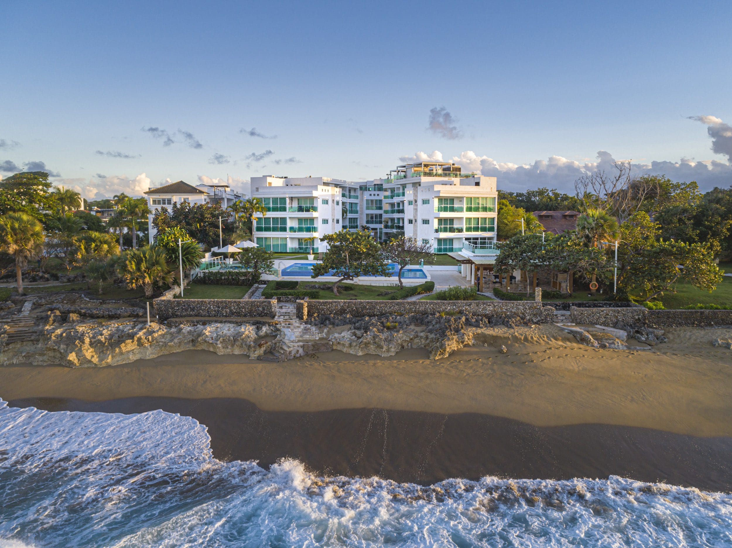 buyDRproperty Oceanfront condo for sale in Sosua with beach access and blue pool. Sosua Real Estate