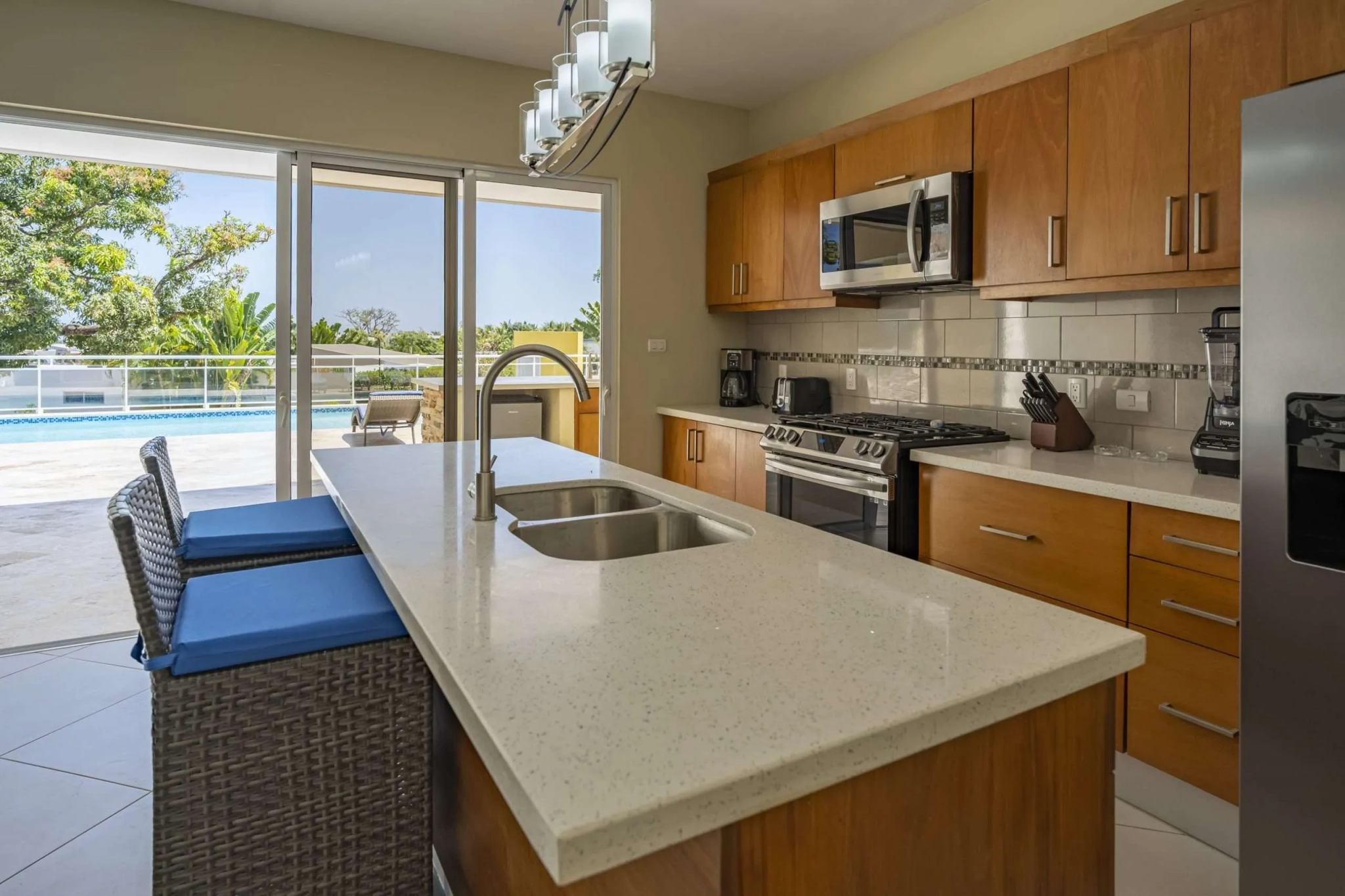 buyDRproperty Villa Seashell Casa Linda kitchen with island, pool view Sosua Real Estate