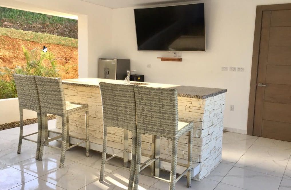 buyDRproperty Modern outdoor bar with seating in a Beautiful Villa SEASHELL in Casa Linda. Sosua Real Estate