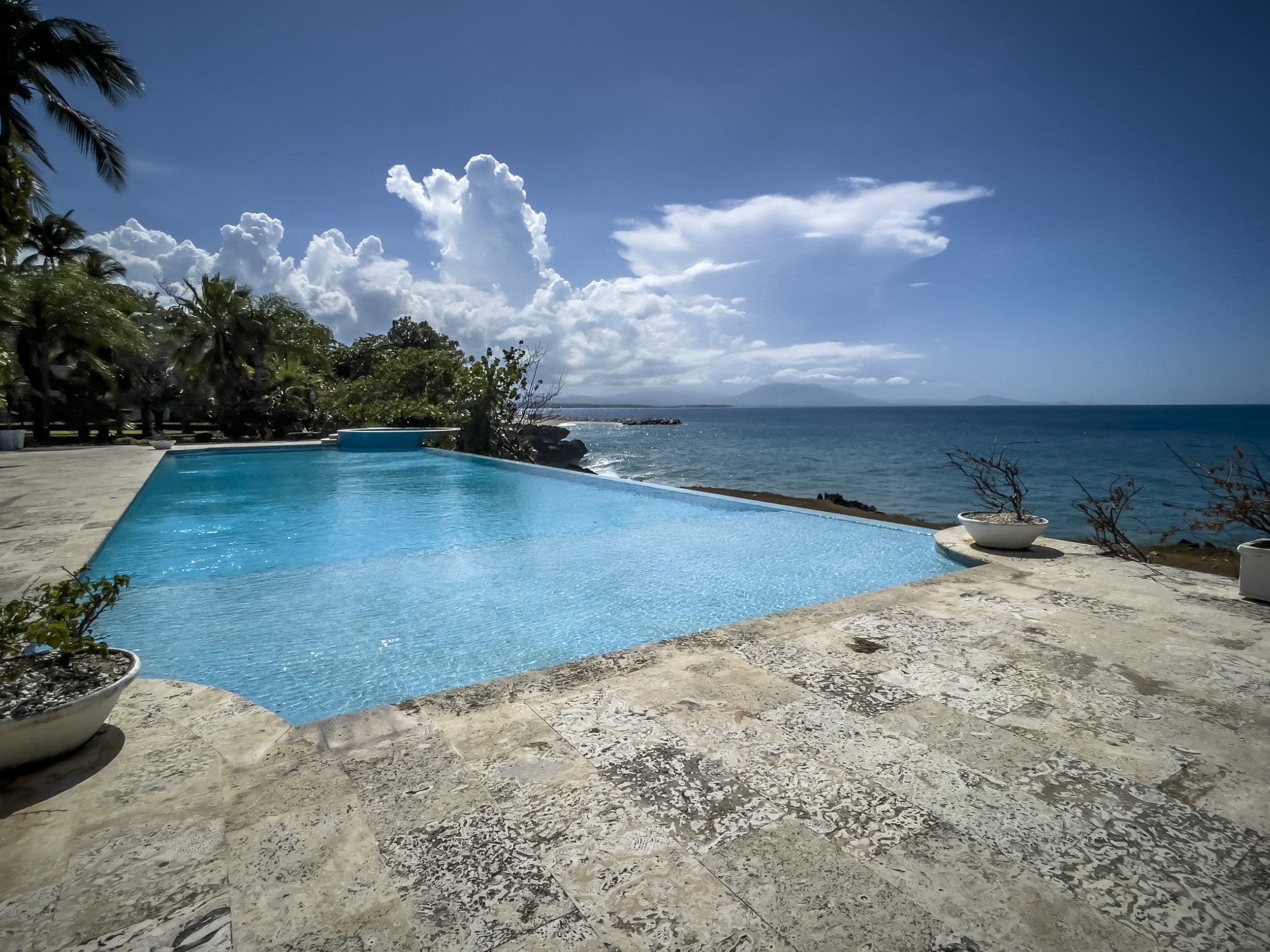 buyDRproperty Infinity pool overlooking the ocean from a 3 Bedroom Oceanfront Condo in Sosua Sosua Real Estate