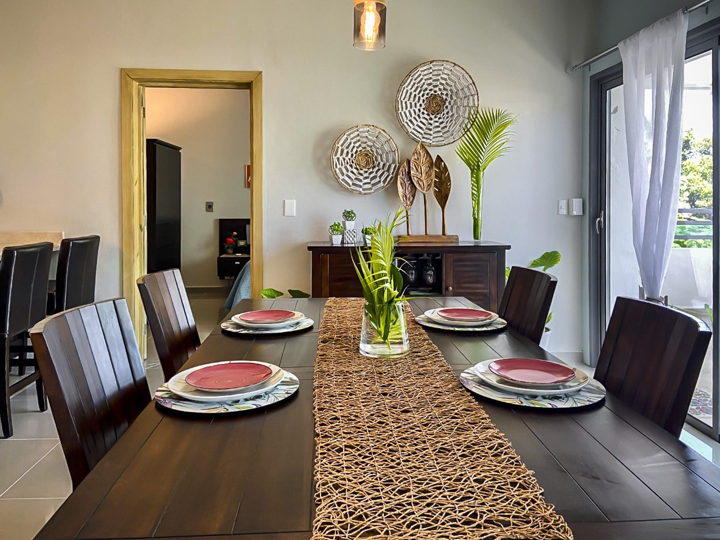 buyDRproperty Dining room table set for a meal in a ProCab penthouse. Sosua Real Estate