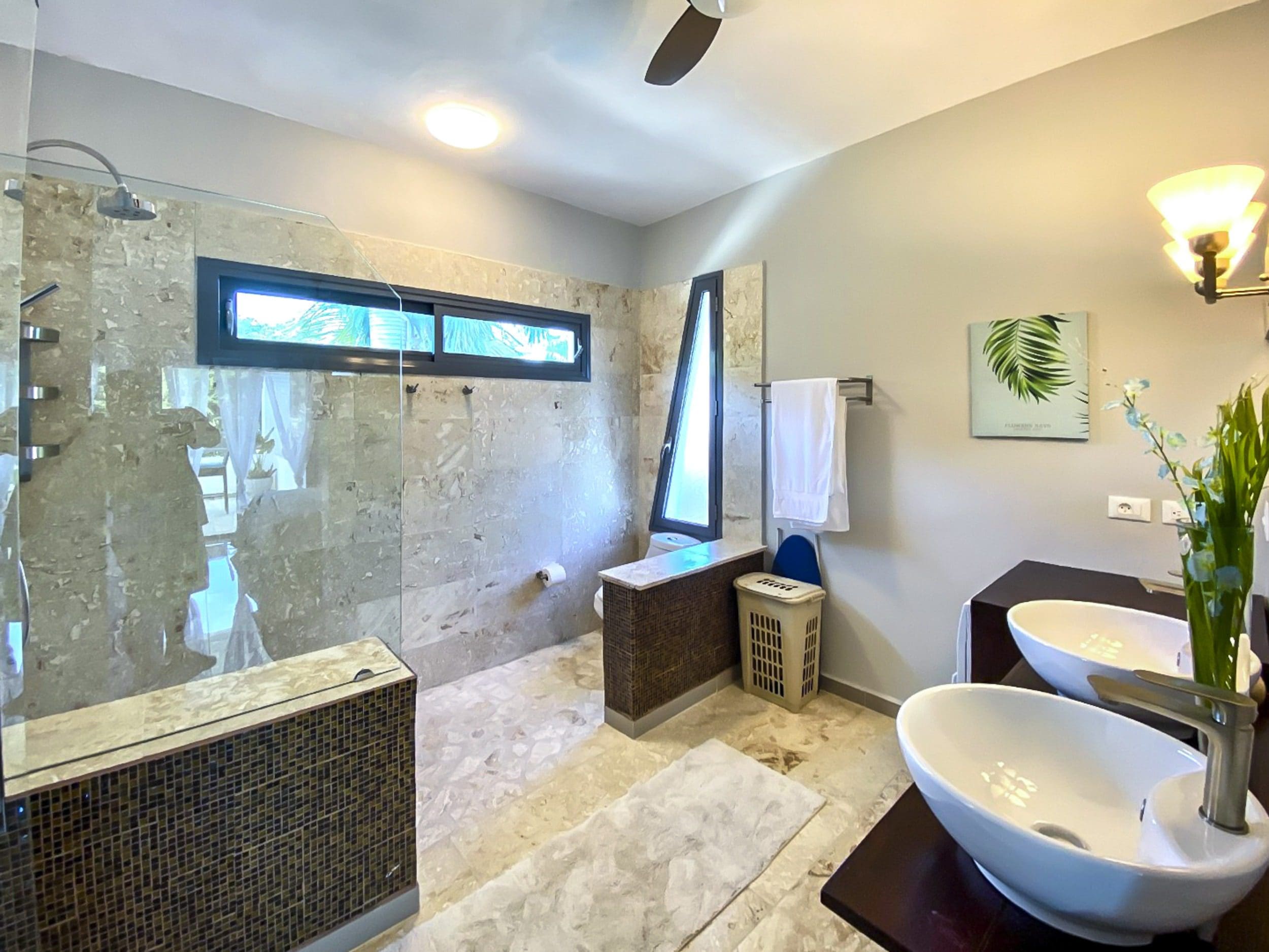buyDRproperty Modern bathroom with walk-in shower, vessel sinks, and unique tile design. Sosua Real Estate