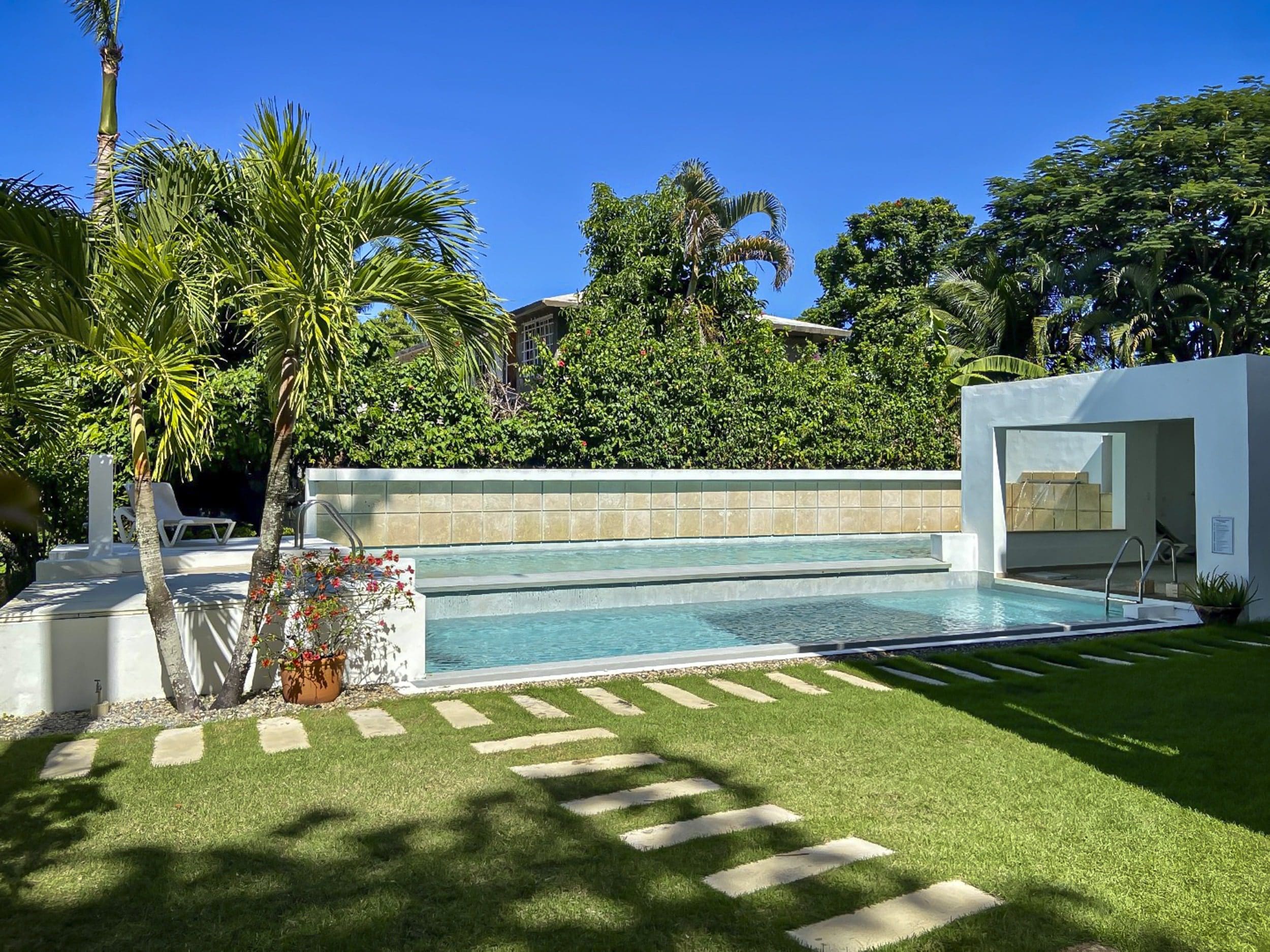 buyDRproperty Luxurious pool area in a tropical setting, perfect for a ProCab penthouse. Sosua Real Estate