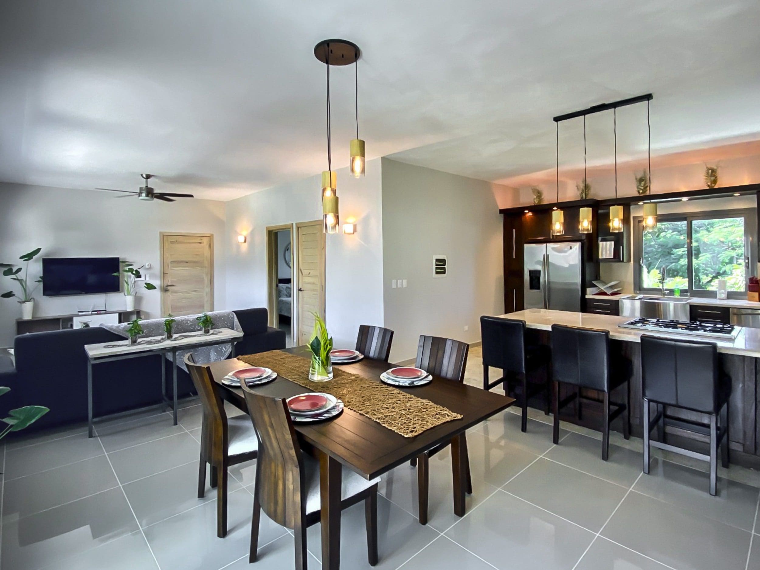 buyDRproperty Modern open-concept living space with dining area and kitchen. Sosua Real Estate