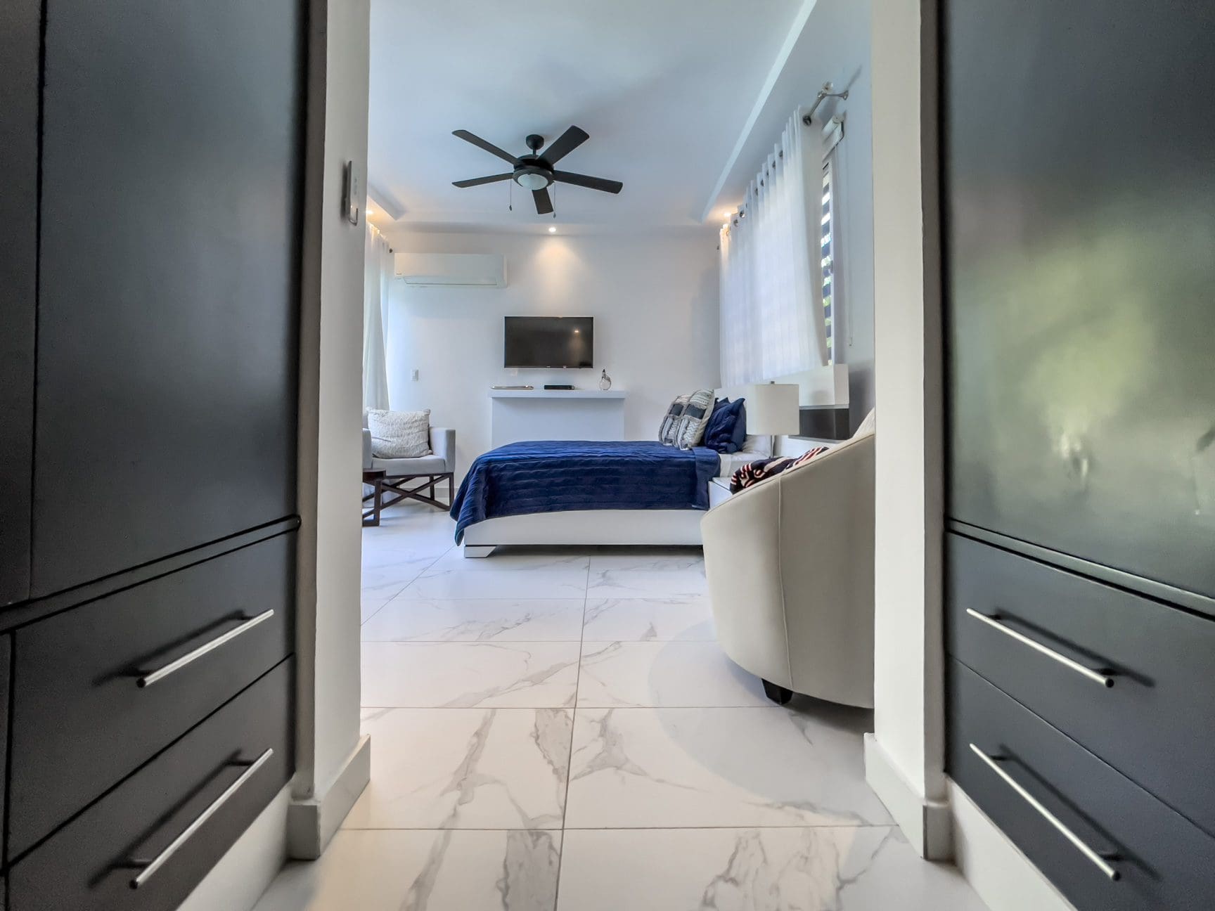 buyDRproperty Modern 3-bedroom villa interior in Sosúa Ocean Village, featuring a bedroom with ocean view. Sosua Real Estate