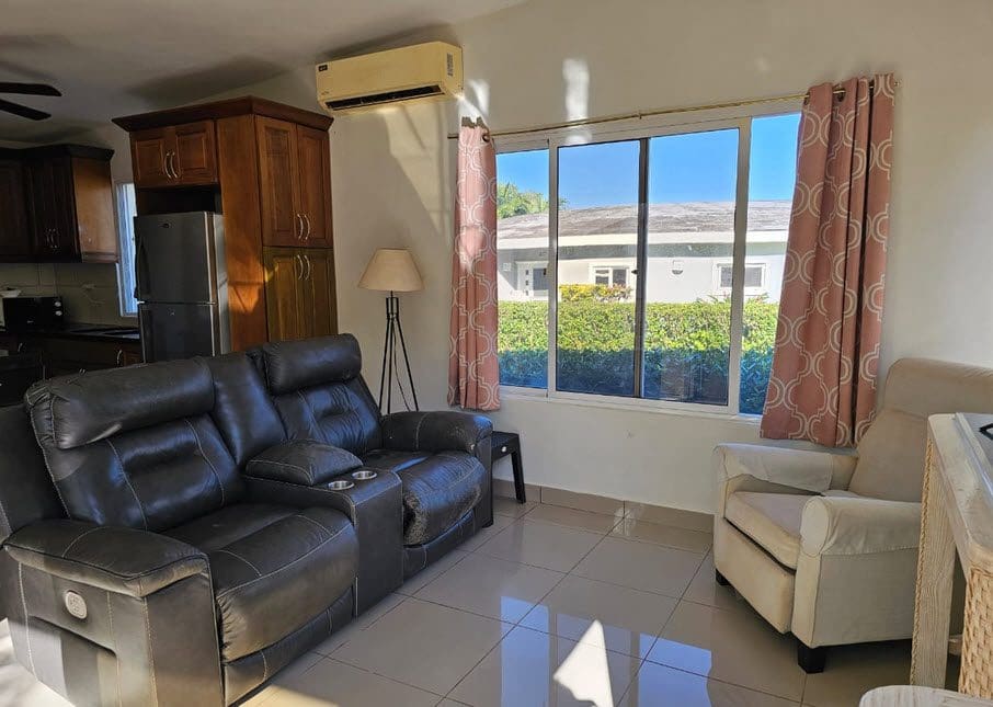 buyDRproperty Living room of a Casa Linda Villa with leather recliner and window view. Sosua Real Estate