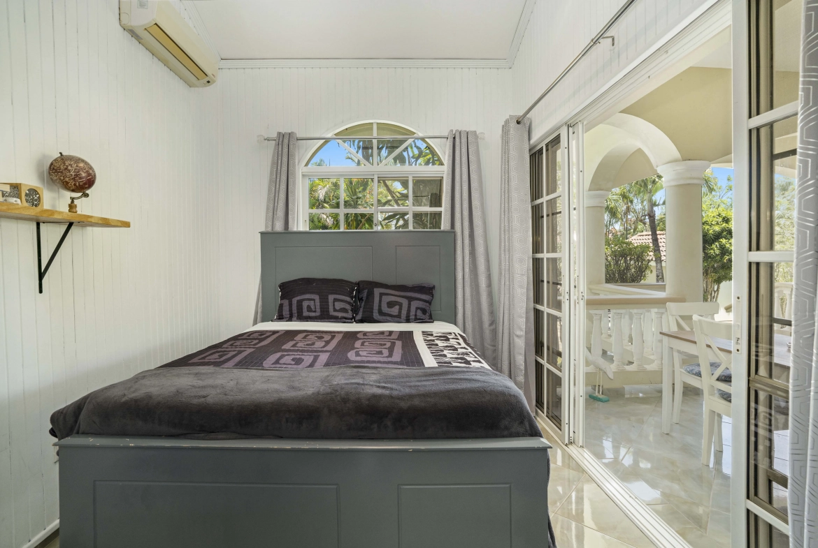 buyDRproperty Beautiful bedroom with a bed, window, and view to the outside area. Sosua Real Estate