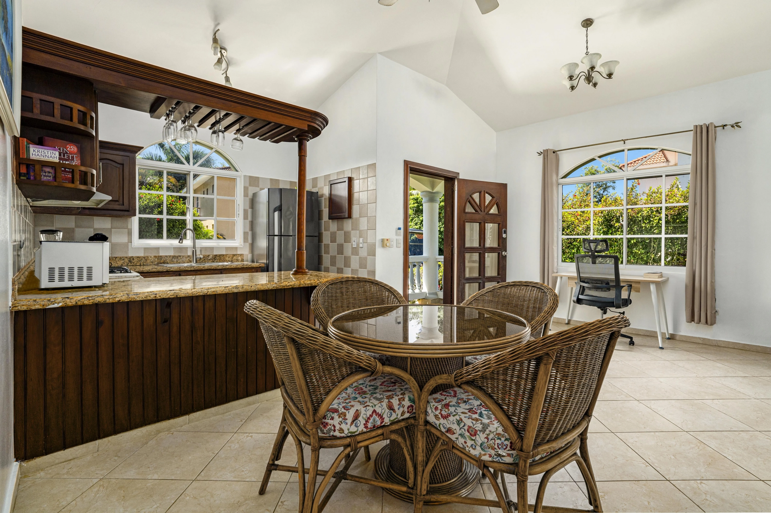 buyDRproperty Dining area with wicker chairs and a glass-topped table in an oversized villa. Sosua Real Estate