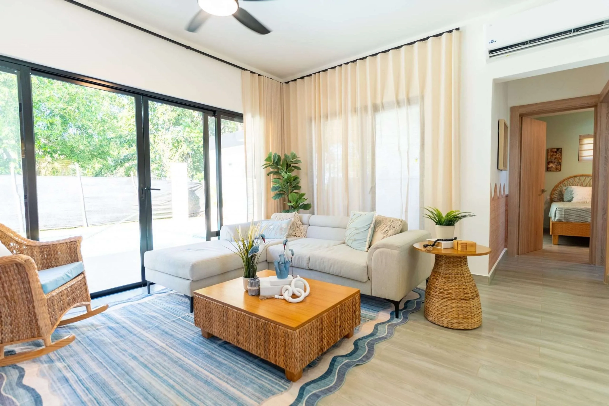 buyDRproperty Modern living room with sectional sofa, wicker chairs, and coffee table. Sosua Real Estate