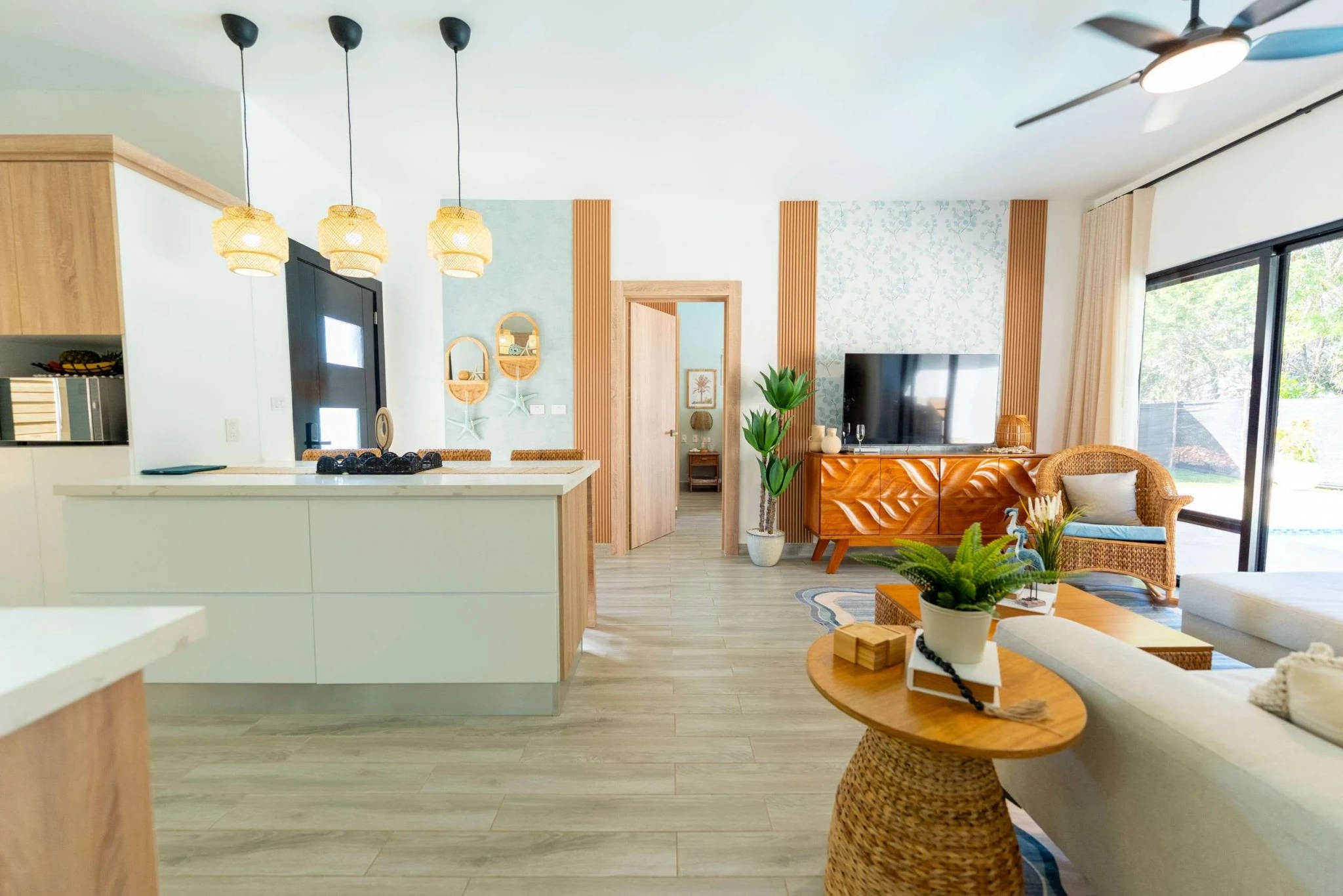 buyDRproperty Modern open-plan living and kitchen area with natural wood accents and coastal decor. Sosua Real Estate