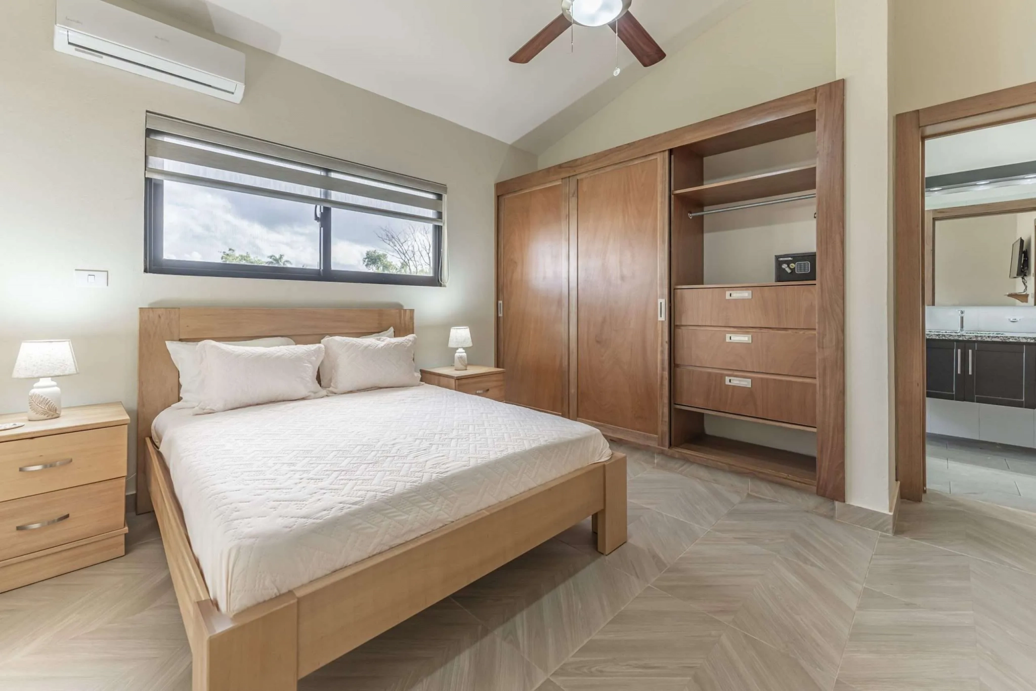 buyDRproperty Modern bedroom with queen bed, large closet, and window view Sosua Real Estate