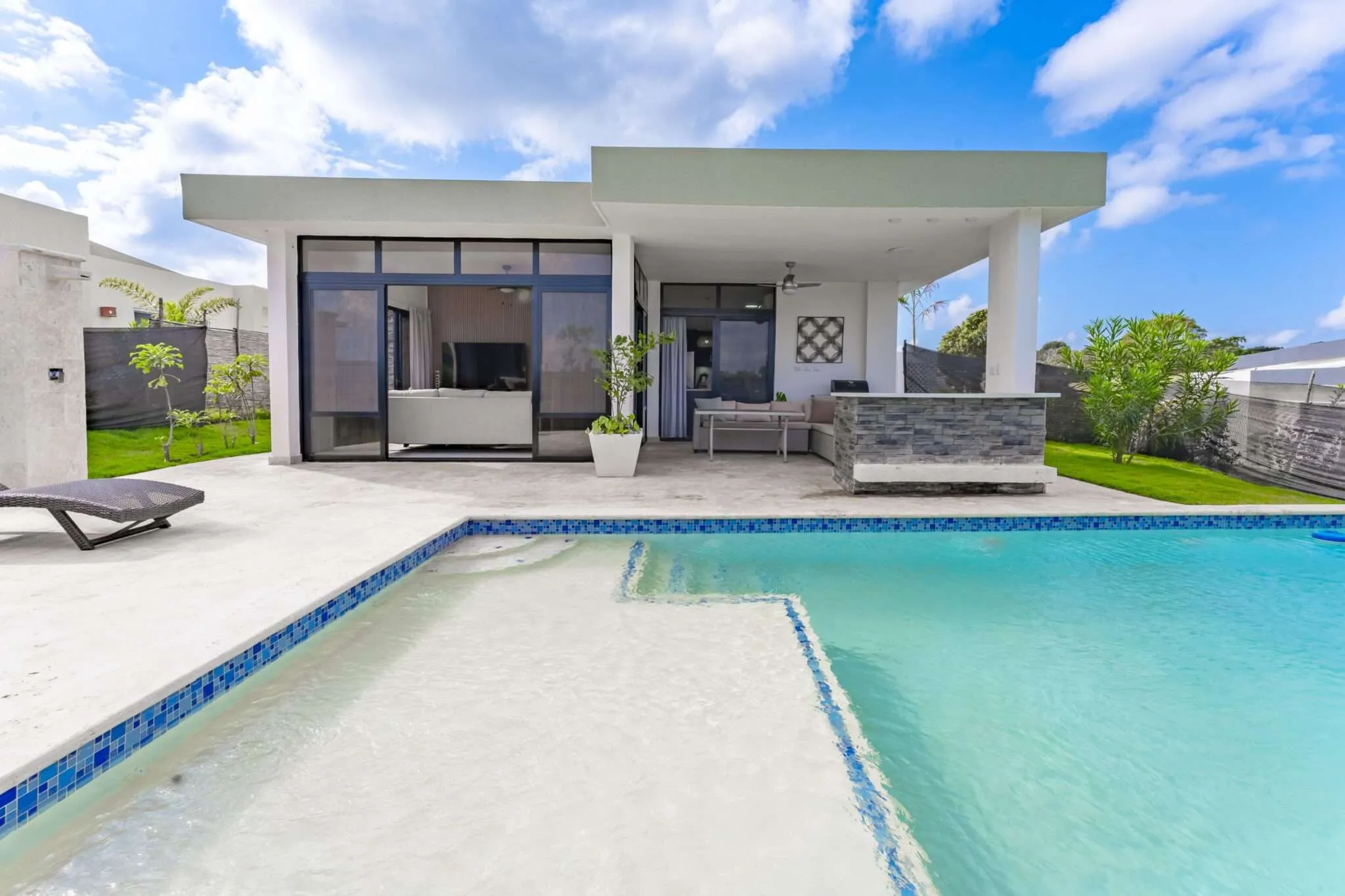 buyDRproperty Modern villa with swimming pool and outdoor seating area Sosua Real Estate