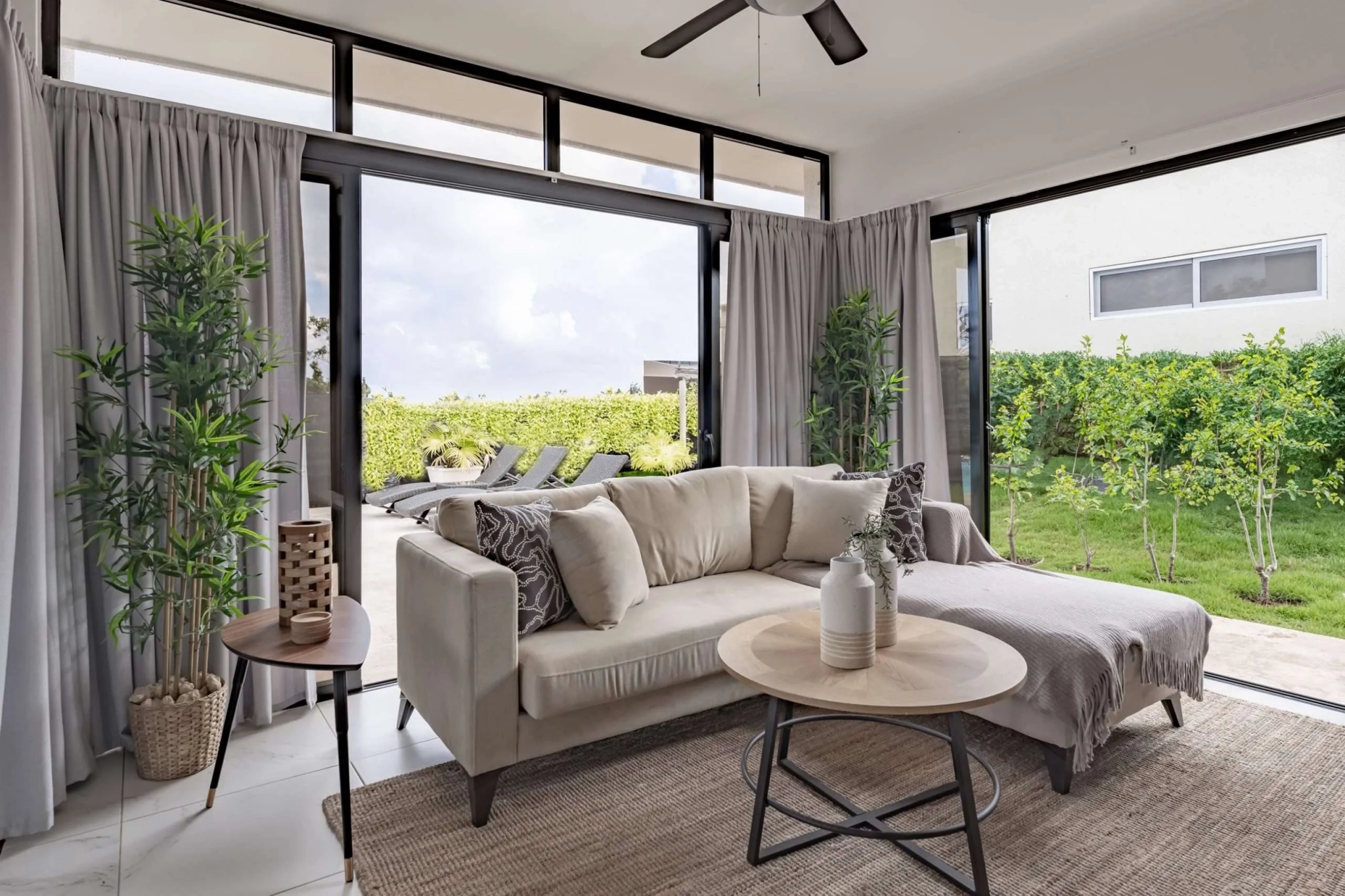 buyDRproperty Modern living room with sectional sofa, coffee table, and outdoor view Sosua Real Estate