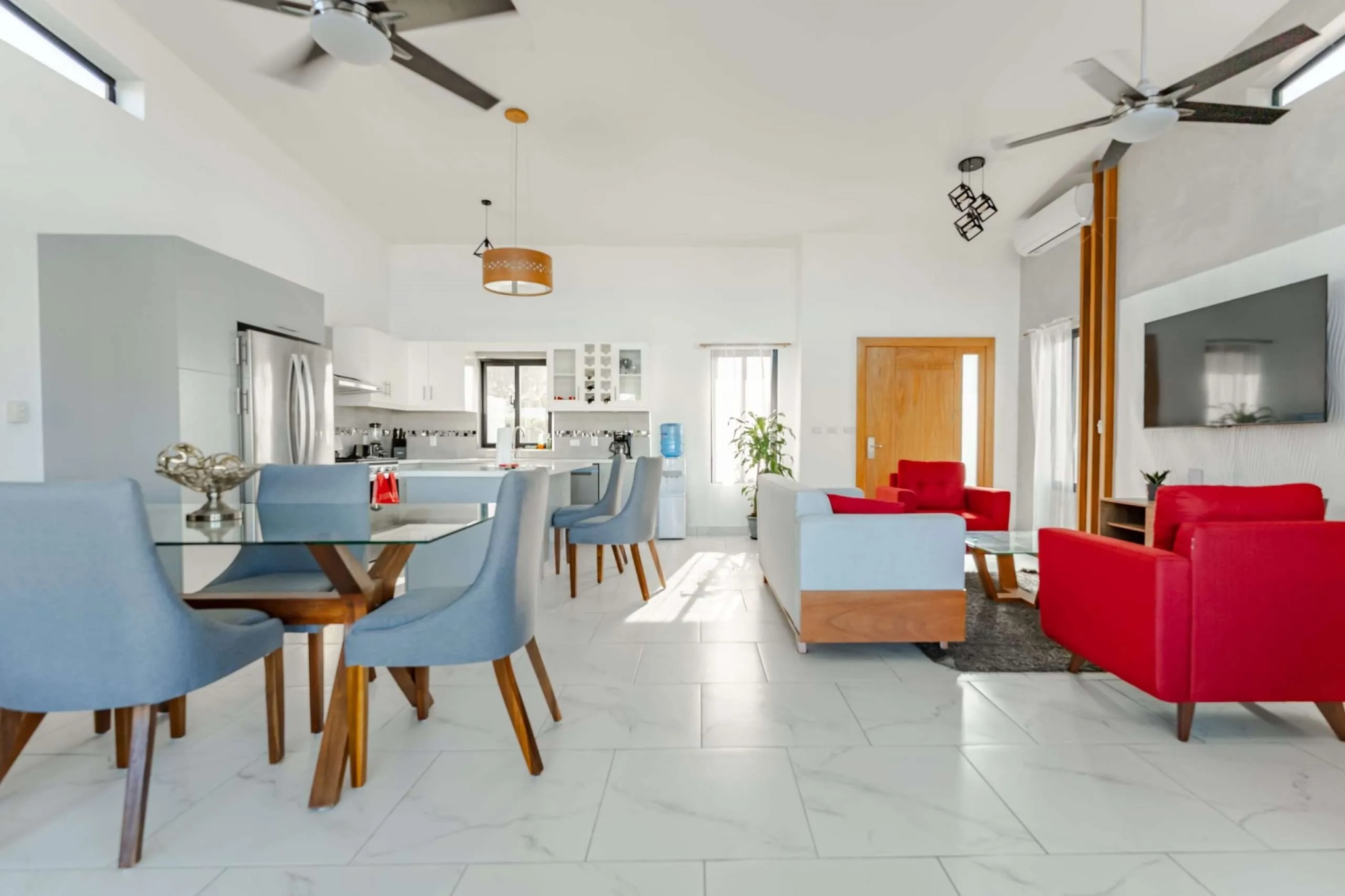 buyDRproperty Modern open-plan living and dining area with a sleek kitchen Sosua Real Estate