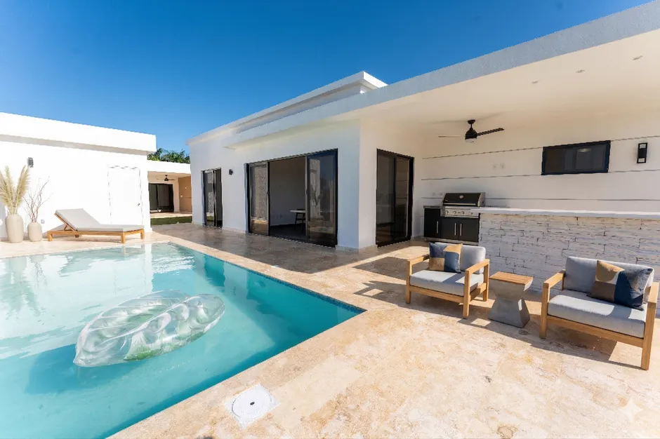 buyDRproperty Modern villa with swimming pool, outdoor kitchen, and lounge area Sosua Real Estate