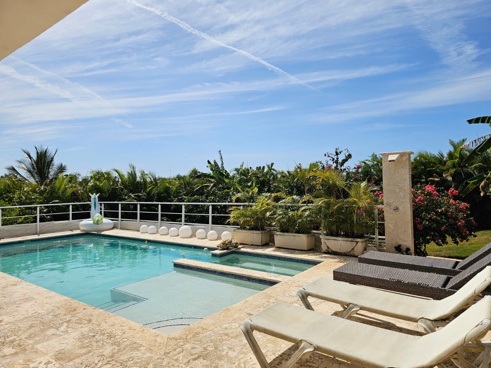 buyDRproperty Luxury villa with pool, lounge chairs, and tropical garden Sosua Real Estate