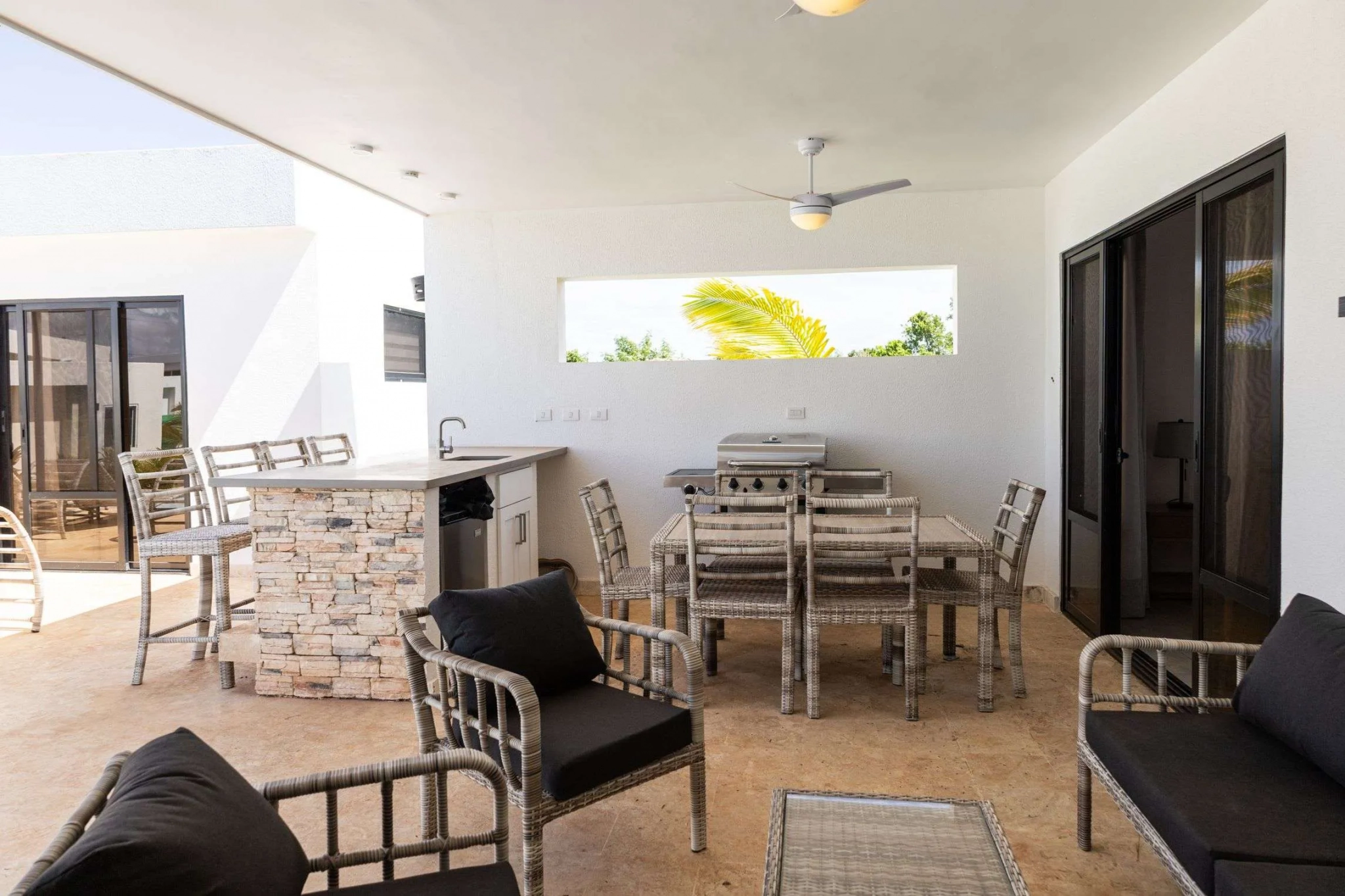 buyDRproperty Outdoor patio dining area with grill, bar, and seating Sosua Real Estate