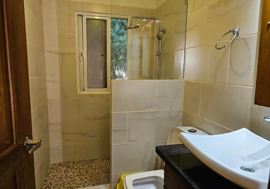 buyDRproperty Modern bathroom at Casa Linda Villa with walk-in shower and designer sink. Sosua Real Estate