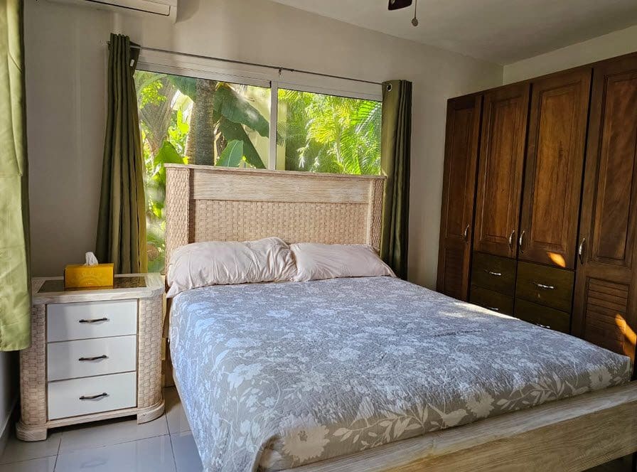 buyDRproperty Bedroom in a Casa Linda Villa with bed, nightstand, and wardrobe. Sosua Real Estate