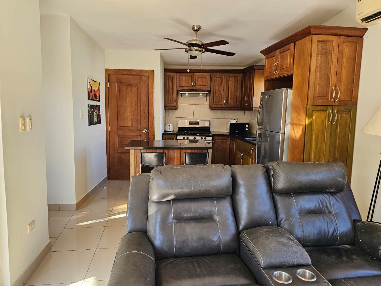 buyDRproperty Cozy kitchen in a Casa Linda Villa with wooden cabinets and a breakfast bar. Sosua Real Estate