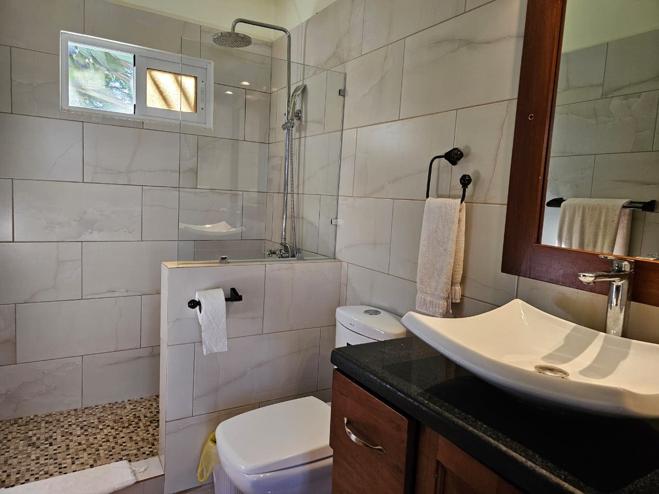 buyDRproperty Modern bathroom with shower, toilet, and sink in a Casa Linda Villa. Sosua Real Estate