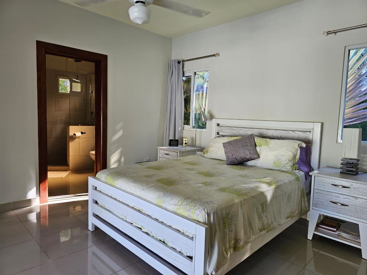 buyDRproperty Bedroom in a Casa Linda Villa with white bed frame and ensuite bathroom. Sosua Real Estate